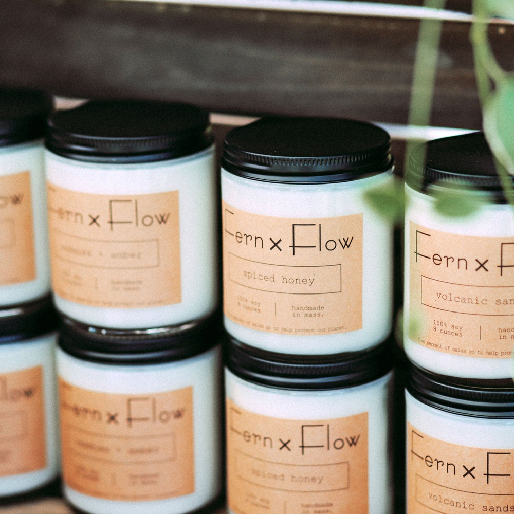 Fern x Flow Signature soy Candle Collection table display at a local farmer's market in Boston..